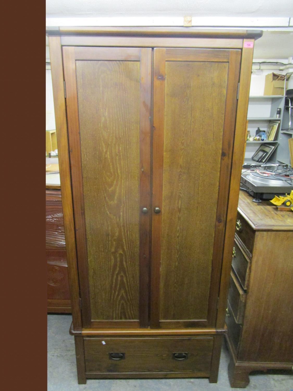 A contemporary hardwood wardrobe with twin doors, single base drawer and square feet 75" x 35" x