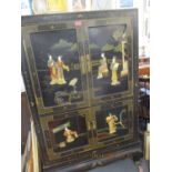 A black Chinoiserie cabinet depicting Japanese figures, fauna and birds having four cupboard