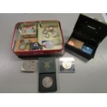 A selection of coins, badges and commemorative medals