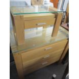 A modern light oak chest of three long drawers and having a glass top, 36" h x 41"w, together with a