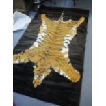 A faux fur rug decorated with a tiger, 93" x 55"