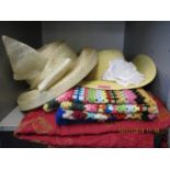 Two ladies hats, a 1970s knitted throw and a red, tasselled table cloth