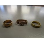 A 22ct yellow gold band, 6.25g, an 18ct yellow gold band, 6.30g and a 9ct rose gold and buckle