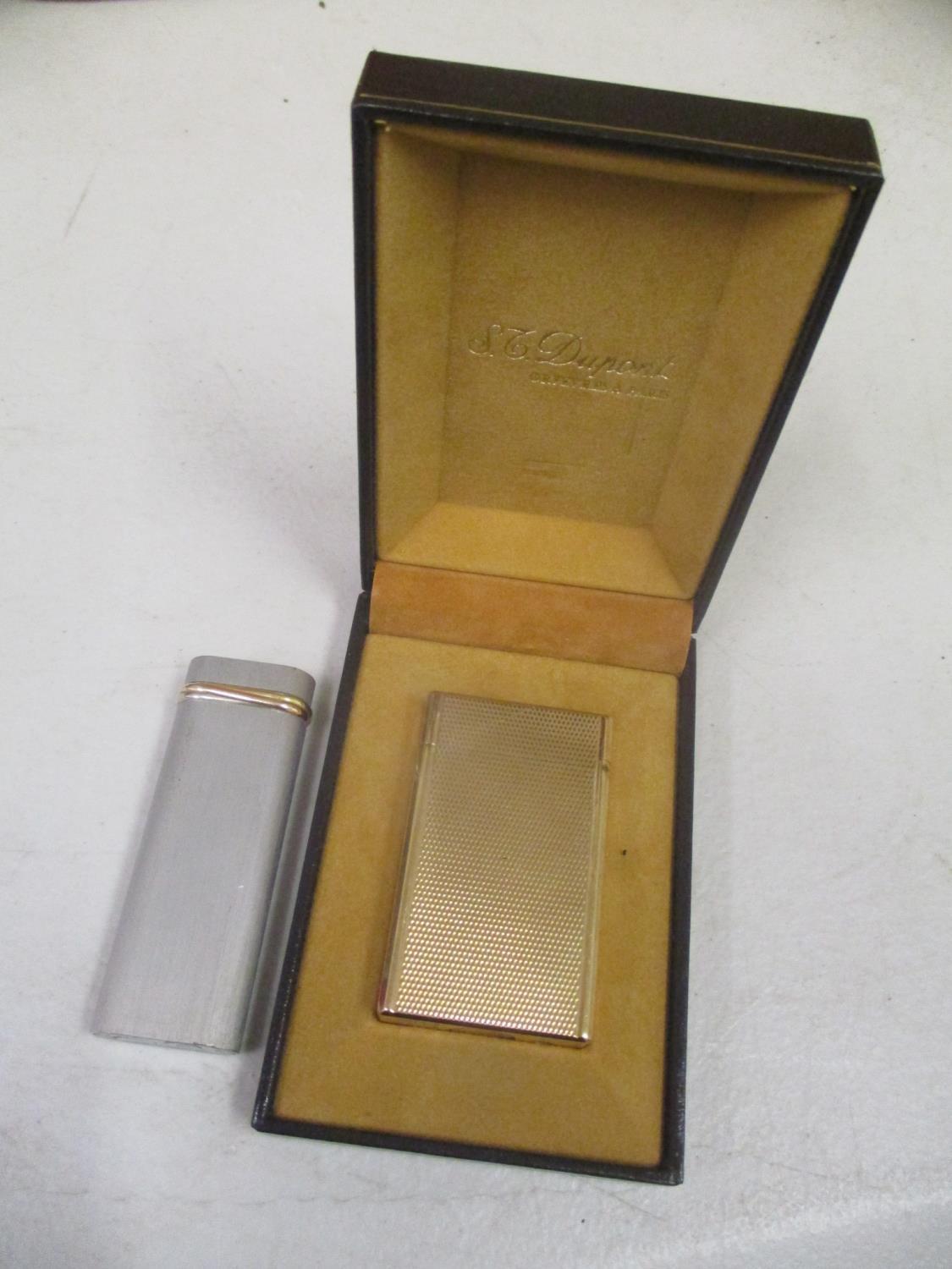 A boxed DuPont lighter, together with a Cartier lighter
