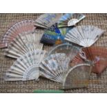 A quantity of fans dated early 20th century to 1970s, to include silk and bone examples, some A/F,