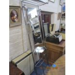 An Art Deco chrome plated tubular hall stand with a mirrored back shelf and hooks and a stick