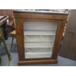 A Victorian walnut glass fronted pier cabinet having applied gilt metal mounts and inlaid
