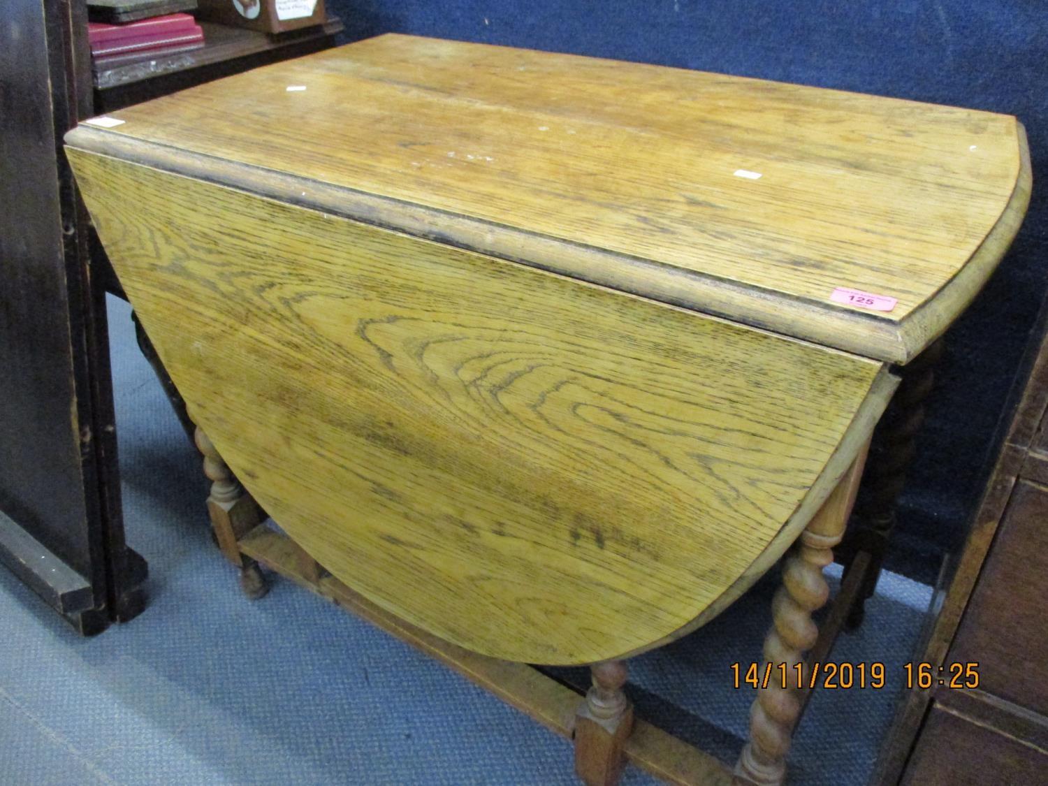 A 1930s oak gateleg table