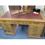 A pine twin pedestal desk with brown leather scriber 30" x 53" x 28"