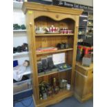 A modern pine bookcase on bracket plinth 66"h x 35"w