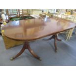 A reproduction mahogany extending dining table and a set of dining chairs