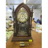 An American Ansonia gothic style wooden cased mantle clock with key and pendulum