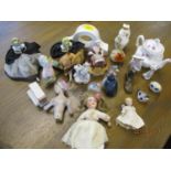 A collection of ceramic dolls and powder puff ladies torsos