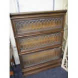 Circa 1900 a three section bookcase with backed glass panels