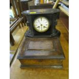 A Victorian ebonized mantel clock with white enamelled Roman dial with twin winding holes, and