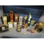 A lot of mantle clocks to include wooden cased miniature longcase clocks