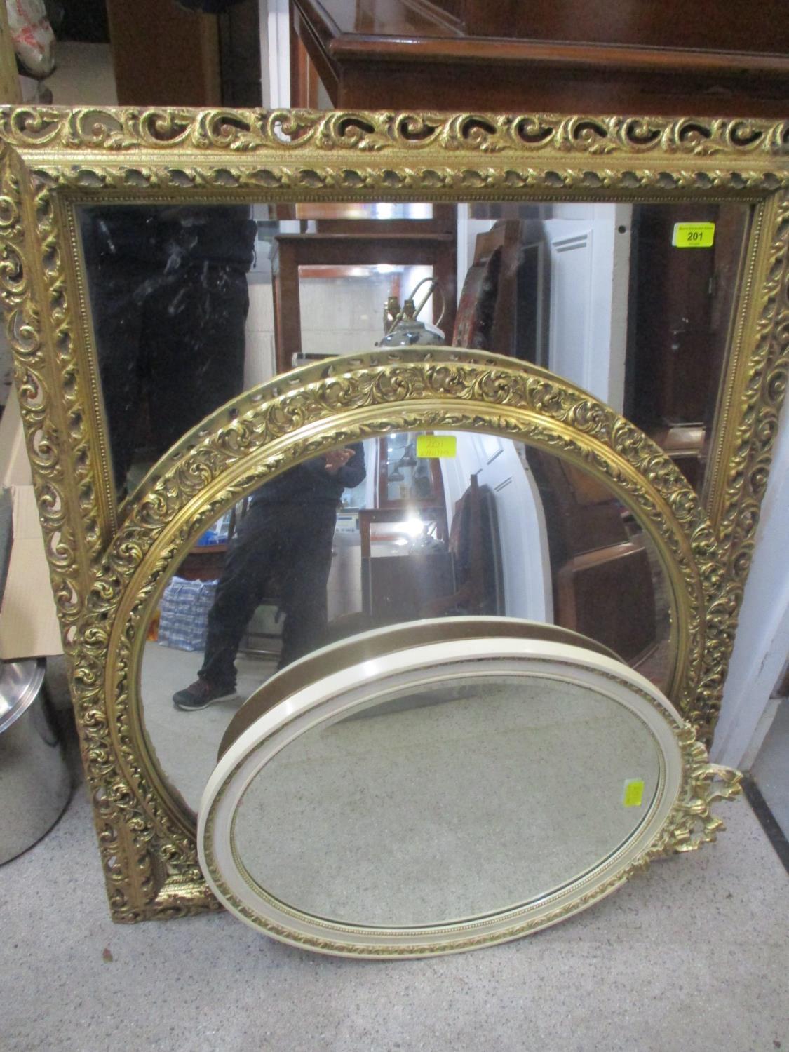 Three mirrors to include two gilt examples and a cream and gilt oval mirror with bow ornament