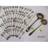 A white metal ladle and another, together with collectors teaspoons and sugar tongs