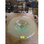 An Art Deco period glass fruit bowl, green tinted with acid etched circular band decoration on an