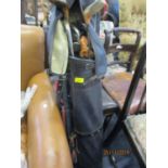 Mixed set of golf clubs in a black leather golf bag