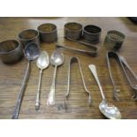 A quantity of silver and silver plated napkin rings and spoons and sugar tongs
