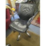 Three faux black leather and chrome swivel office chairs with arms and castors