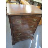 A reproduction mahogany bookcase in the form of a chest of drawers having single door revealing