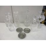 Five modern cut glass decanters and a cut glass lamp, along with three pewter dishes