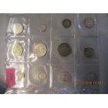 A group of silver world wide coins to include a 1913 one rupee coin and a 1966 half dollar coins