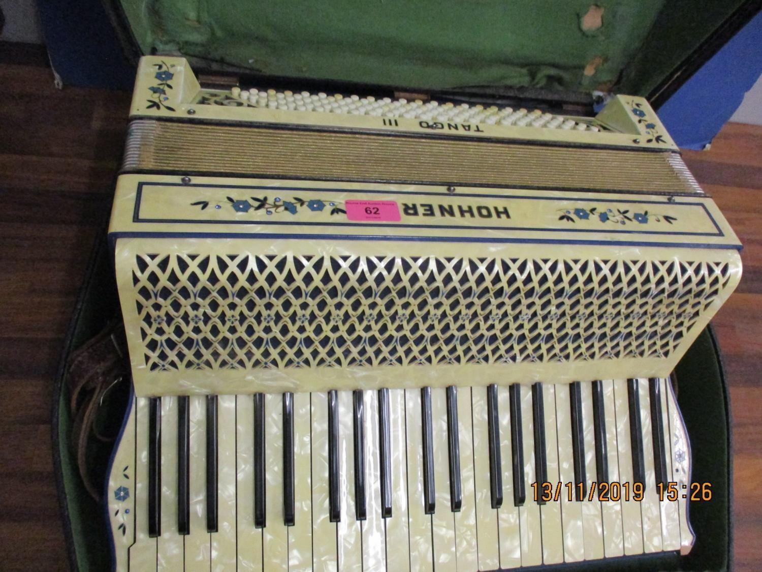 A Honer Tango III piano accordion with a mother of pearl effect case