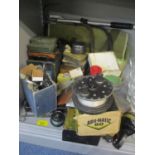 A selection of fishing items to include reels, fly boxes and other items