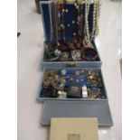 A retro jewellery box containing 20th century costume jewellery, mainly bangles, two amber style
