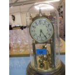 A mid 20th century anniversary clock under a glass dome