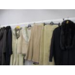 Four ladies full length coats to include a Marks & Spencer's light beige suede with faux fur trim,