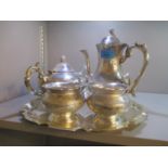 A silver plated four piece teaset and a tray