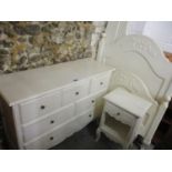 A modern off white painted bedroom suite comprising of a bedside cabinet, a single bed and a chest