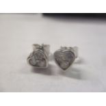 A pair of 18ct white gold heart shaped earrings, each inset with three diamonds, with paperwork
