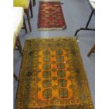 An orange ground Middle Eastern rug, together with a smaller red ground rug, having a chevron design