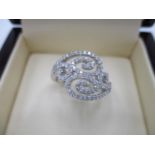 A Tivon 18ct white gold ring of scrolled design set with diamonds, approximately 0.42ct