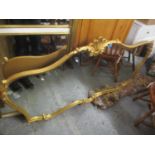 A modern rococo style gilt framed wall mirror having shell and scroll decoration, 36" h x 66"w