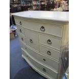 A modern cream painted chest of eight drawers on cabriole legs