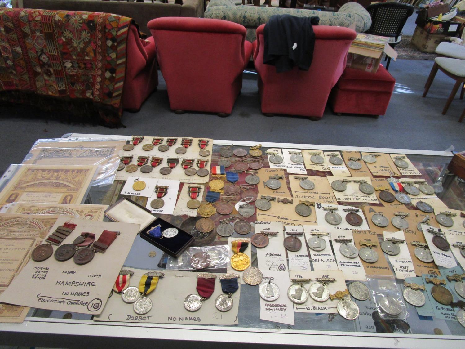 A collection of Victorian and Edwardian school and Education silver, bronze and metal medals, a