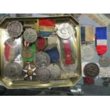 A group of medals to include a French 1883 agricultural merit silver and enamelled medal, a silver