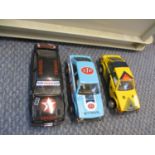 A quantity of Scalextric to include three cars and four controllers
