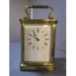 An early 20th century brass carriage clock having white enamelled dial with Roman numerals, 4 1/4"