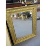 An ornate gilt wall mirror, 36" x 28"