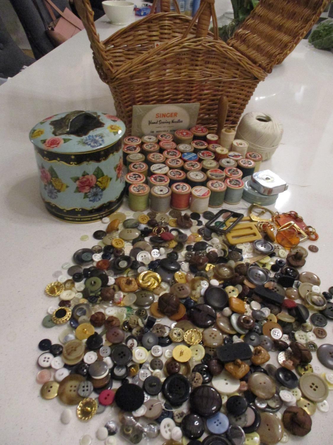 A sewing basket and contents to include wooden cotton reels such as Silko and Barbours, together