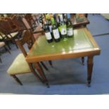 An oak framed desk with leather scriber and gilt rail, fluted squared legs with later castors and an