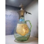 A German Historimus green glass claret jug with pewter lid having a mounted lion