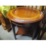 A modern mahogany and burr inlaid, circular topped, two tier occasional table on square tapering